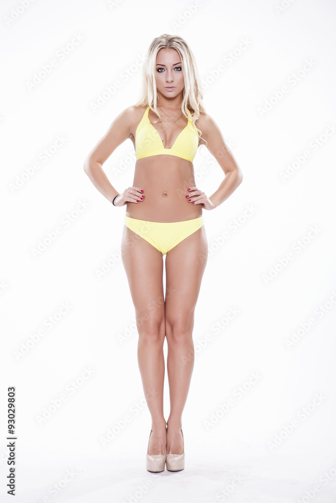 Sexy blonde woman wearing pink swimwear posing on white backgrou Sexy blonde woman wearing pink swimwear posing on white backgrou