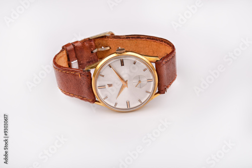 Old classic wristwatch for man with brown strap on white