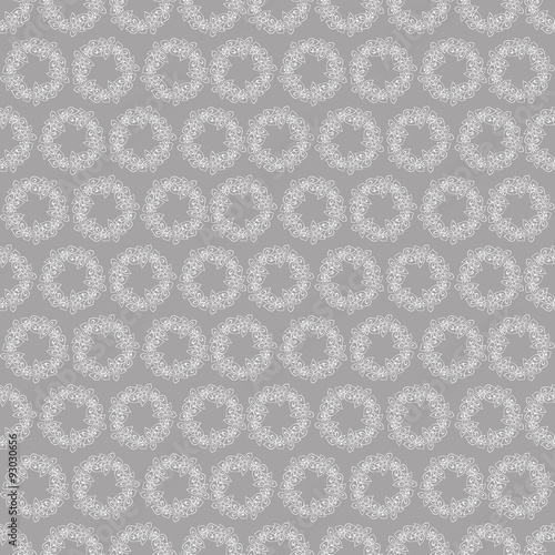 Seamless pattern with wreaths of white flowers on a grey background