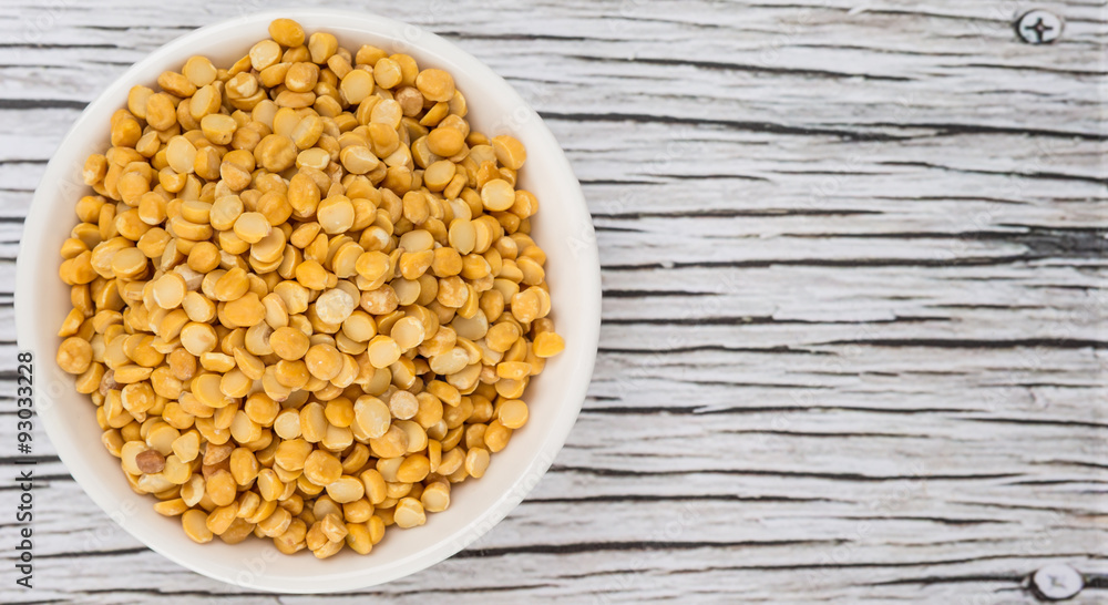 Raw Indian dhal in white bowl over wooden background Raw Indian dhal in white bowl over wooden background