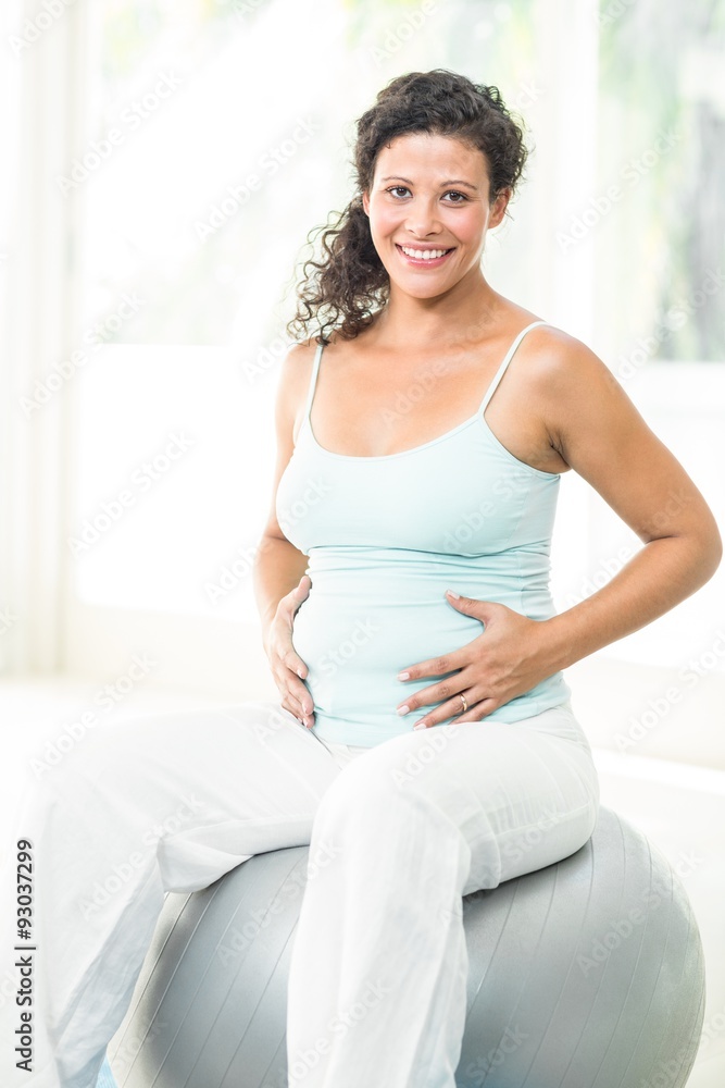 Happy pregnant woman touching her belly Happy pregnant woman touching her belly