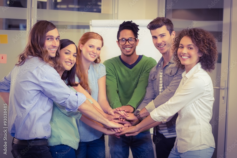 Portrait of smiling business people with hand stacked Portrait of smiling business people with hand stacked