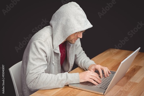 Businessman with hooded shirt working on laptop
