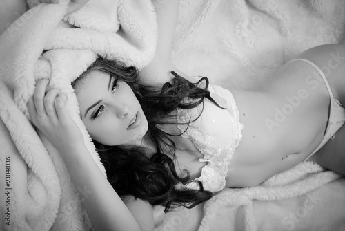 Picture of beautiful adorable sexy young lady laying in white photo