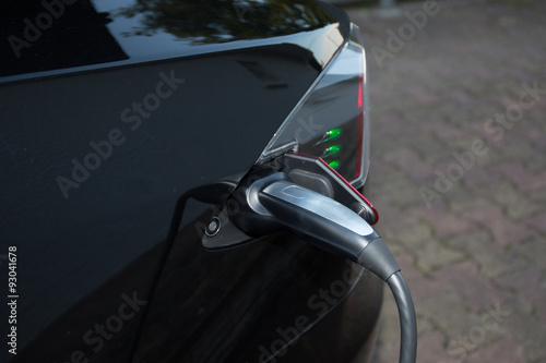 Loading energy of an electric black car photo