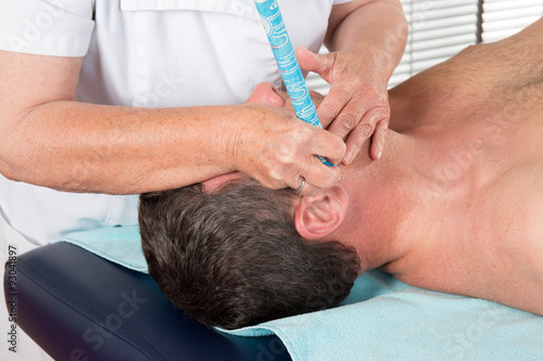 Alternative medicine therapist doing moxa treatment on her client