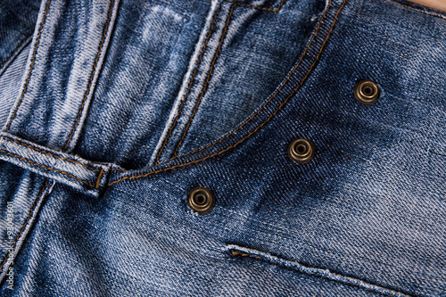 fashionable clothes. pile of jeans on a wooden background