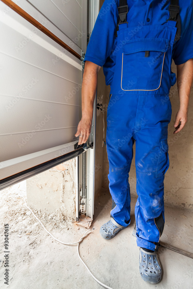 Worker open a garage door during installation