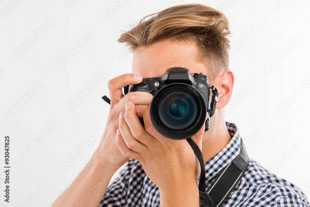 handsome young photographer taking a photo of a viewer handsome young photographer taking a photo of a viewer