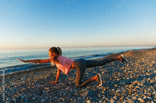 13-15 years girl doing exercises on the beach sports © koss13