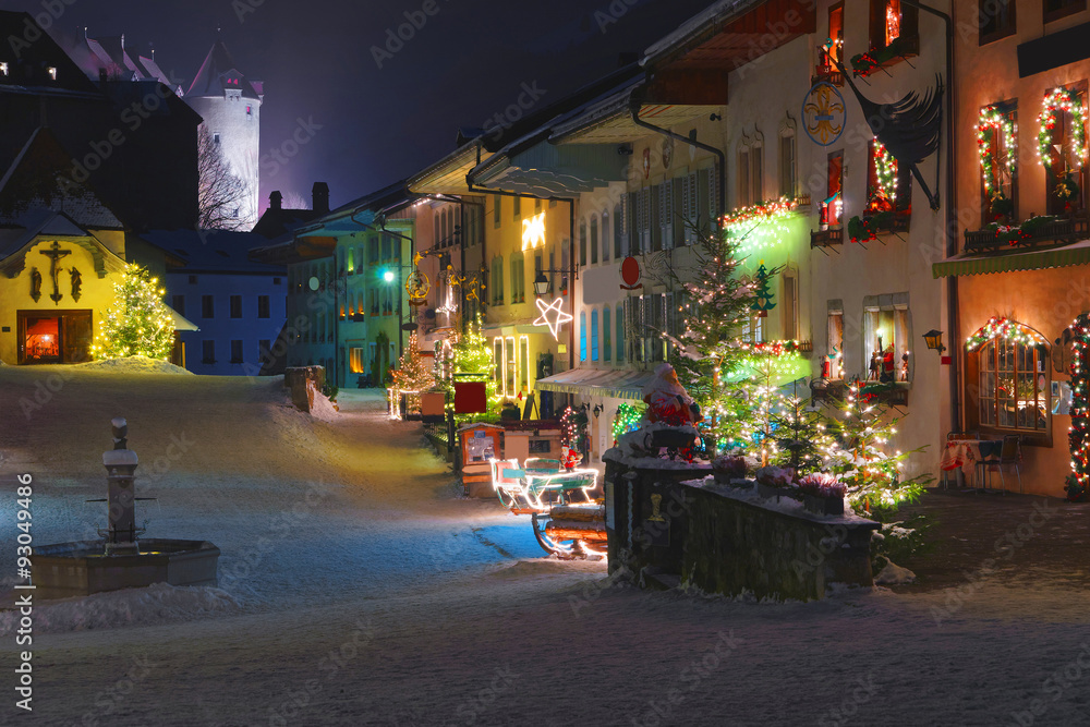 Streets of medieval town of Gruyeres decorated for Christmas