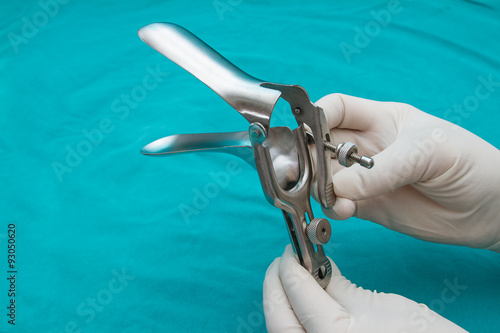 doctor holds a disposable speculum in his hand. photo