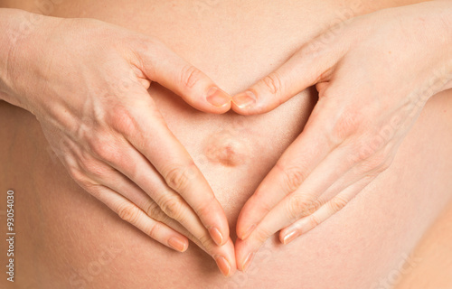 Wallpaper Mural Pregnant belly and heart-shaped hands Torontodigital.ca