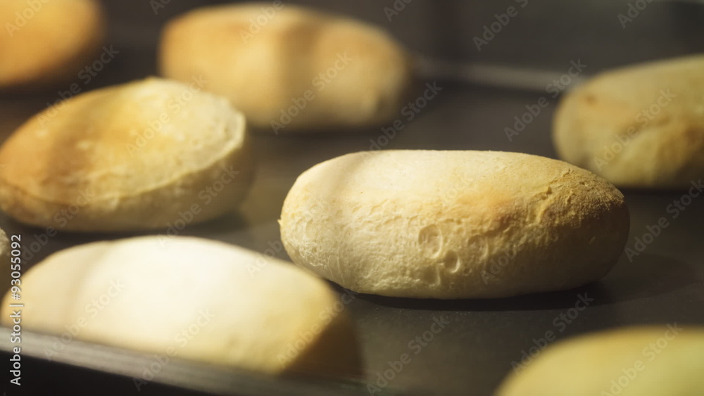 Time lapse of biscuits baking on a cookie sheet in an oven; shallow focus on one biscuit. Time lapse of biscuits baking on a cookie sheet in an oven; shallow focus on one biscuit.