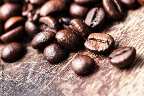 Coffee beans on grunge wooden table top view image  macro