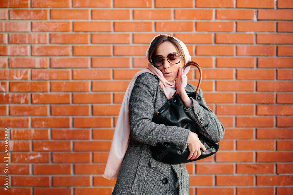 girl in a coat on the street girl in a coat on the street