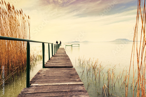 Fotografie, Obraz Wooden pier in tranquil lake Balaton