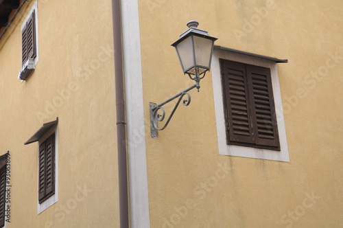 windows with wooden shutters and old fashioned lantern photo