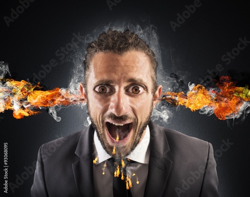 Fototapeta Stressed man spits fire
