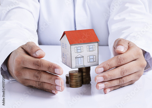 hand protection house paper on coins stack for mortgage loans co