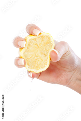 Young woman squeezing lemon