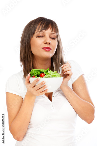 Young woman eating fresh salad