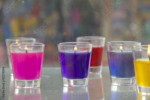 Stock Photo:.Close-up of yellow and red candles in glass holders