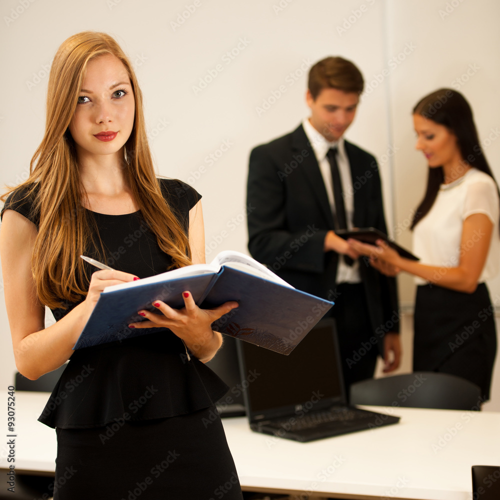 Business woman - secretarry standing in first plain with cowork Business woman - secretarry standing in first plain with cowork