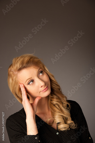 Pretty pensive caucasian blonde business woman looking into copy