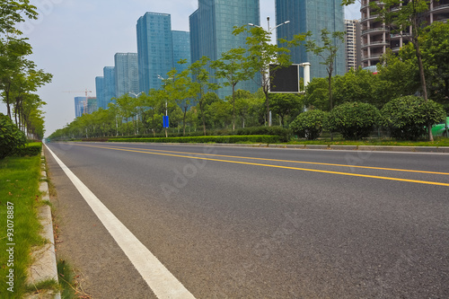 Empty road surface with modern city buildings background © Aania