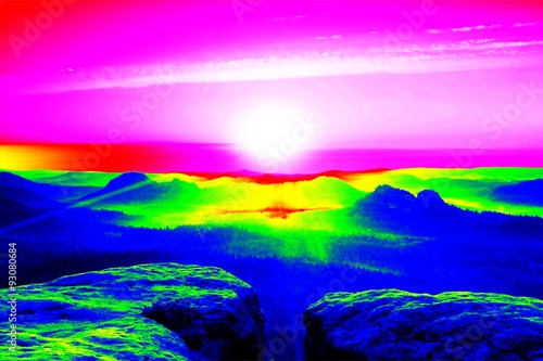 Misty view. Amazing thermography photo of hilly landscape. Autumn sunset above long deep valley with heavy fog above forest.
