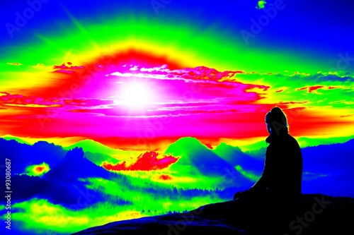 Alone young girl tourist feast daybreak on the sharp corner of sandstone rock and watch over valley to Sun.