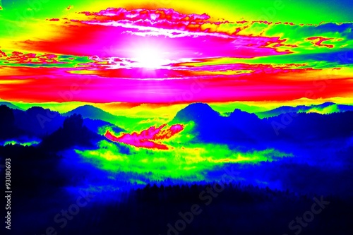 Misty view. Amazing thermography photo of hilly landscape. Autumn sunset above long deep valley with heavy fog above forest.