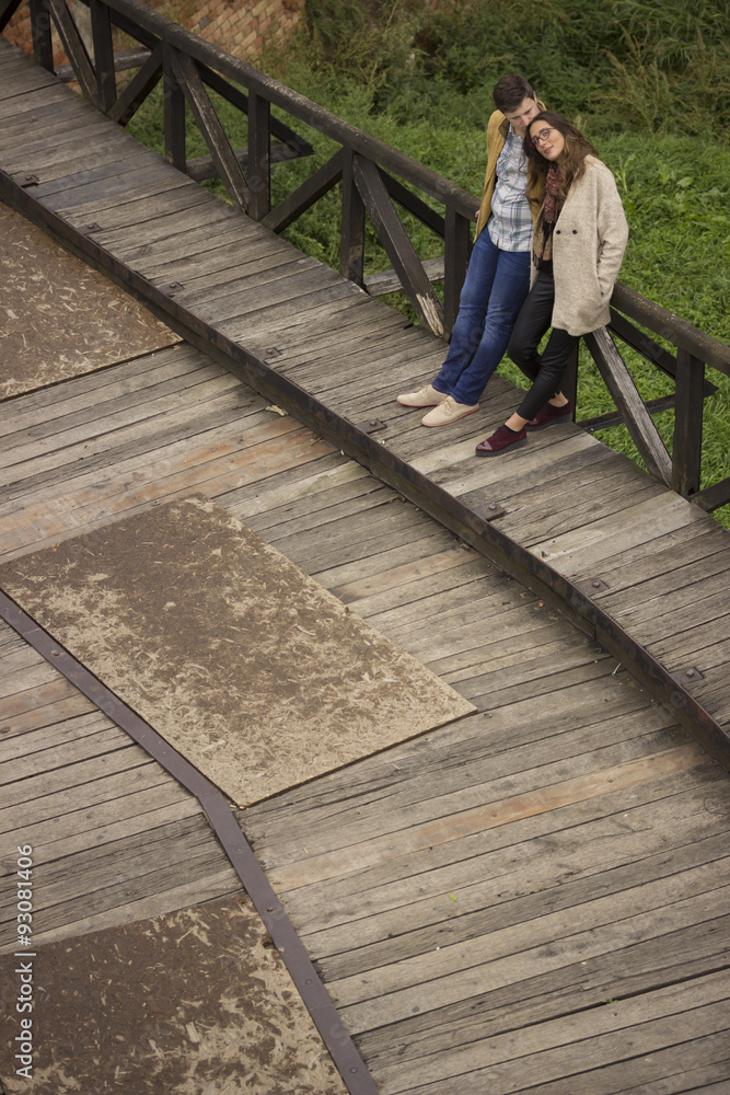 Romantic Intimate couple, boyfriend and girlfriend on wooden br Romantic Intimate couple, boyfriend and girlfriend on wooden br