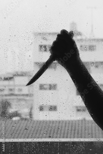 Abstract crime background. Silhouette of someone holding knife