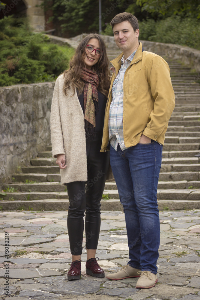 Fototapeta premium young beautiful couple in 20s posing, looking at camera.