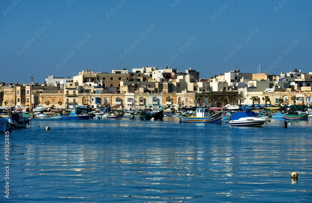 Traditional Maltese village with reflection in the sea, Malta