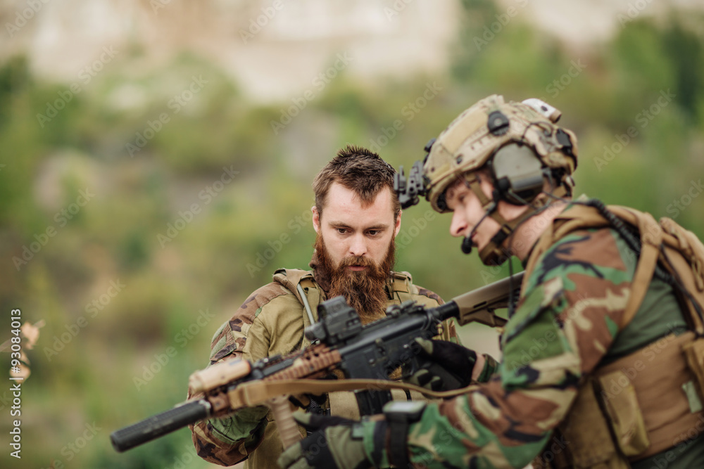 us Instructor with soldier aiming rifle at firing range