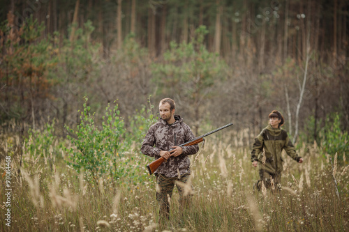 hunters in camouflage clothes ready to hunt with hunting gun