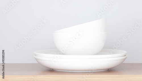 White plate and white bowl in kitchen cabinet