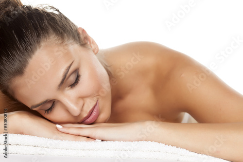 portrait of a beautiful young woman lying on a white background