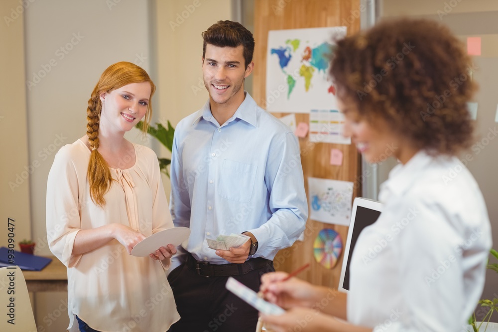 Fototapeta premium Business people standing in office with female colleague 