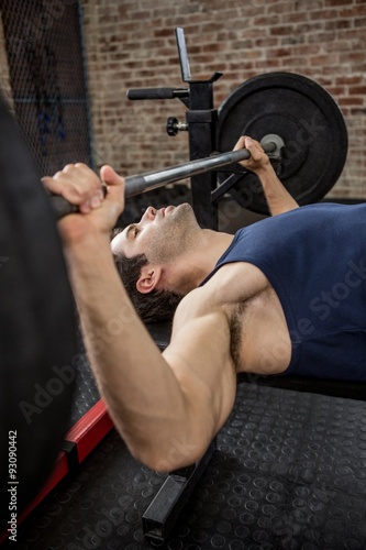 Side view of man holding barbell