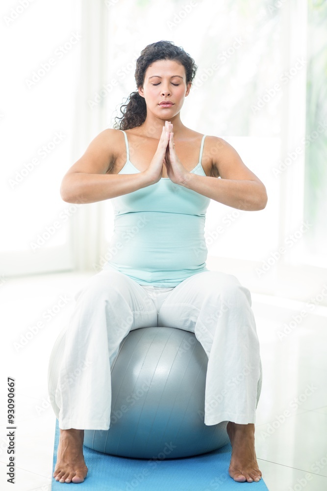 Pregnant woman with joined hands and eyes closed Pregnant woman with joined hands and eyes closed