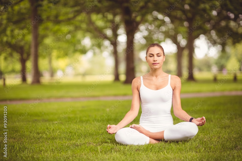 Full length of woman sitting in lotus pose Full length of woman sitting in lotus pose