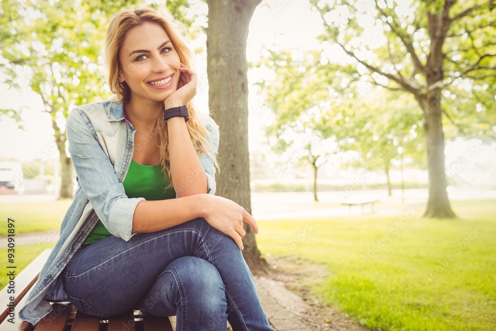Portrait of smiling woman with hand on chin at park Portrait of smiling woman with hand on chin at park