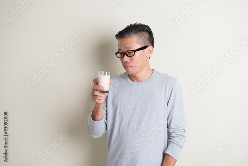 asian senior drinking milk