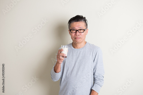 asian senior drinking milk