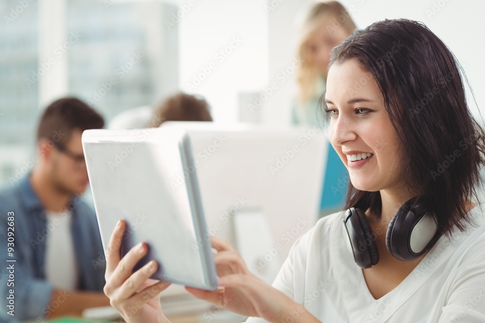 Smiling woman with headphones using digital tablet Smiling woman with headphones using digital tablet