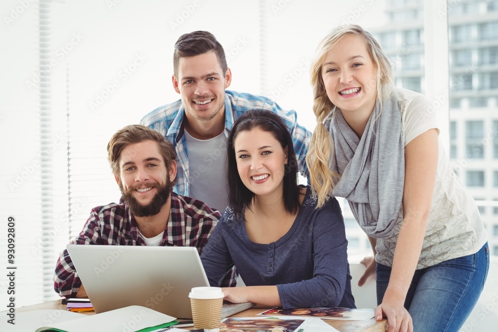 Portrait of smiling business people using laptop Portrait of smiling business people using laptop